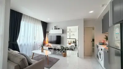 Modern open-plan living room with stylish decor and natural light