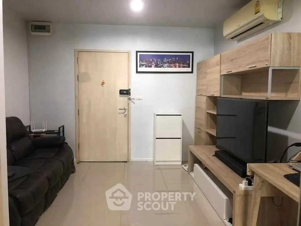 Modern living room with sleek furniture and wall-mounted air conditioner