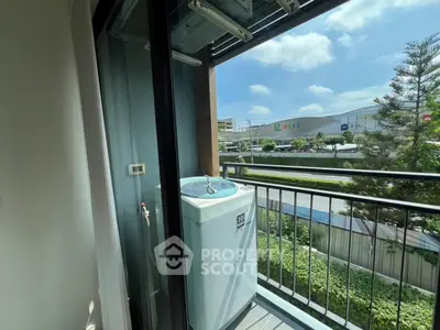 Charming balcony with washing machine and scenic view, perfect for urban living convenience.