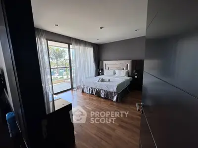 Spacious bedroom with balcony access and modern decor
