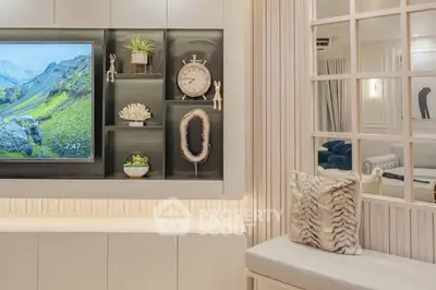 Stylish modern living room with built-in TV and decorative shelving