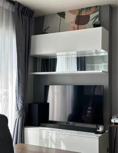 Modern living room with sleek TV setup and stylish shelving unit