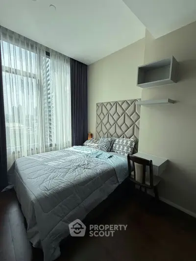 Modern bedroom with large window and stylish decor in urban apartment