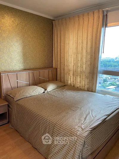 Cozy bedroom with elegant decor and large window offering scenic views