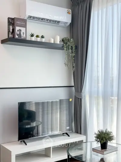 Modern living room with sleek TV, air conditioner, and stylish decor