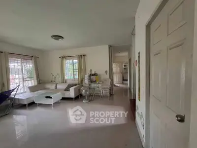 Spacious living room with modern furniture and large windows for natural light.