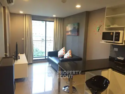 Modern living room with sleek furniture and balcony view in stylish apartment.