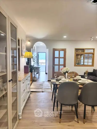 Charming dining area with elegant table setting and cozy living room ambiance.