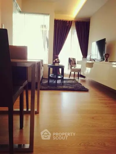 Modern living room with sleek furniture and large windows for natural light.