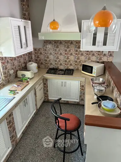 Charming kitchen with gas stove and modern appliances in cozy home