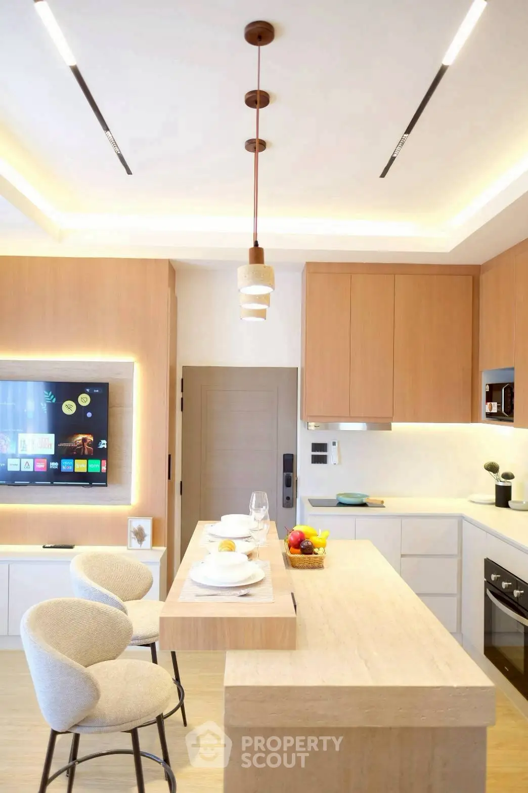 Modern kitchen with sleek design, featuring a breakfast bar and integrated appliances.