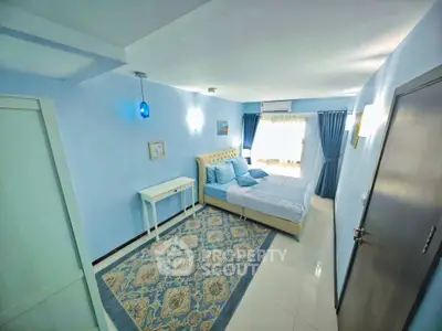 Spacious blue-themed bedroom with elegant decor and natural light