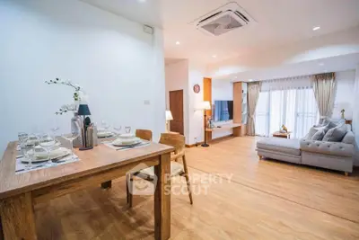 Spacious modern living room with elegant dining area and cozy seating.