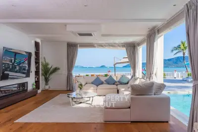 Luxurious living room with ocean view, spacious seating, and elegant decor, perfect for relaxation and entertainment.