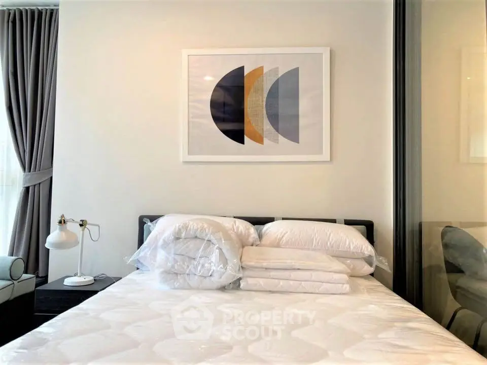 Modern bedroom with stylish decor and cozy bedding in a contemporary apartment.