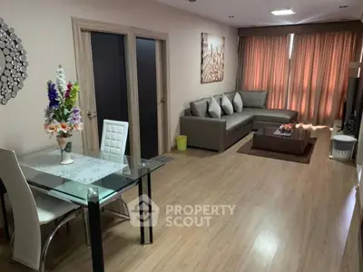 Spacious living room with modern decor and elegant dining area