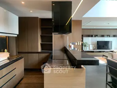 Luxurious modern kitchen with sleek black countertops and open layout in upscale apartment.