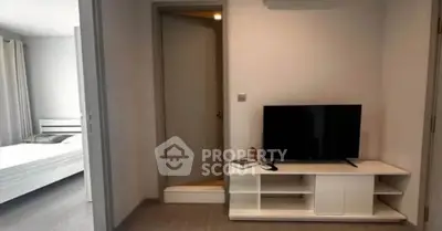 Modern apartment interior with TV unit and glimpse of bedroom, ideal for urban living.