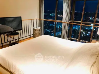 Luxurious bedroom with stunning night city view from large windows, featuring a cozy bed and modern decor.