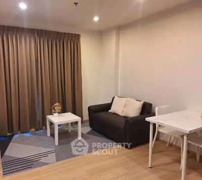 Cozy living room with modern decor and natural light, featuring a comfortable sofa and stylish coffee table.
