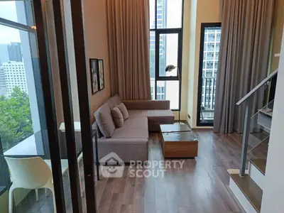 Modern living room with floor-to-ceiling windows and stylish decor in a high-rise apartment.