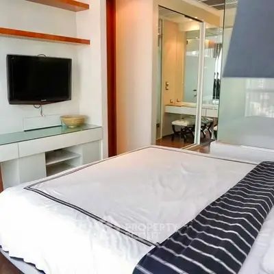 Modern bedroom with sleek design and wall-mounted TV