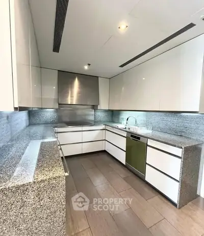 Modern kitchen with sleek cabinetry and granite countertops
