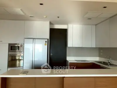 Modern kitchen with sleek cabinetry and built-in appliances in a stylish apartment.