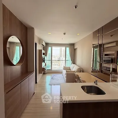 Modern open-plan living room with kitchen and city view balcony