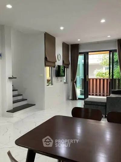 Modern living room with sleek design and garden view, featuring elegant furniture and natural light.