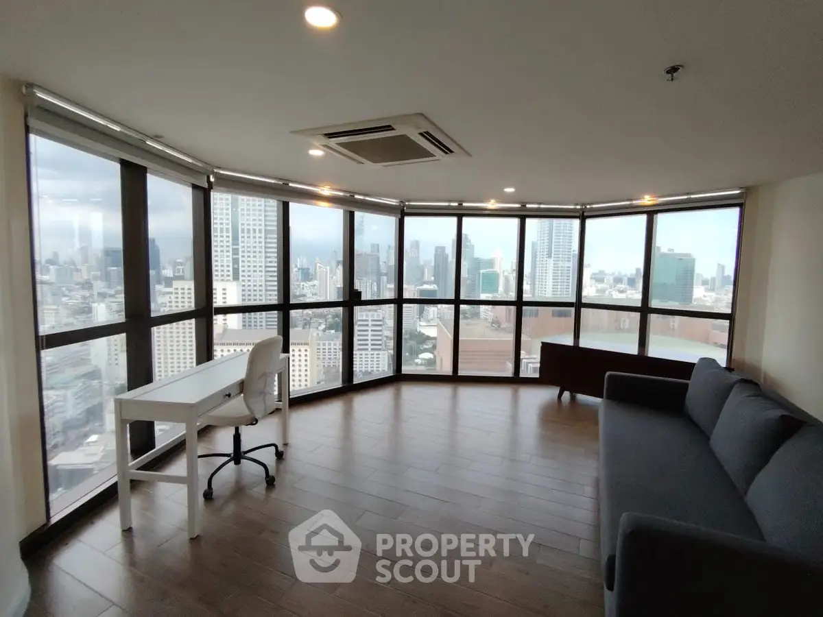 Spacious corner unit with panoramic city views and modern furnishings.