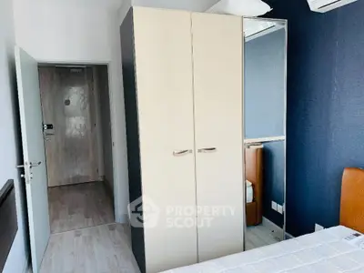 Modern bedroom with sleek wardrobe and air conditioning unit