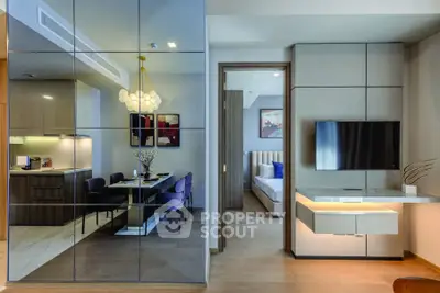 Modern open-plan living and dining area with sleek decor and stylish furnishings.
