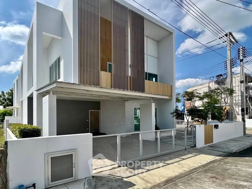 Modern two-story corner unit with sleek design and spacious balcony in a vibrant neighborhood.