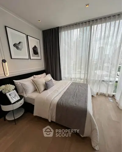 Luxurious bedroom with floor-to-ceiling windows and elegant decor in a modern apartment.