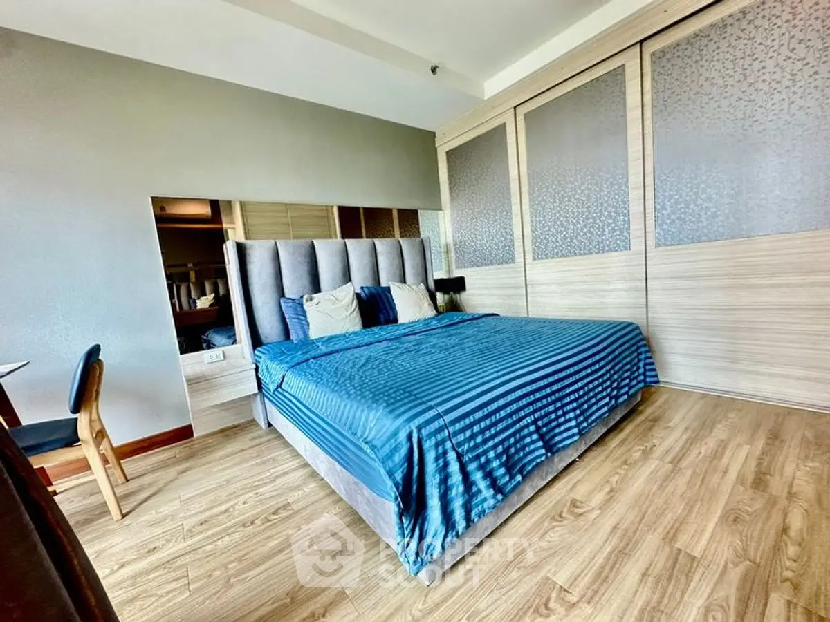 Spacious bedroom with modern design and elegant wooden flooring