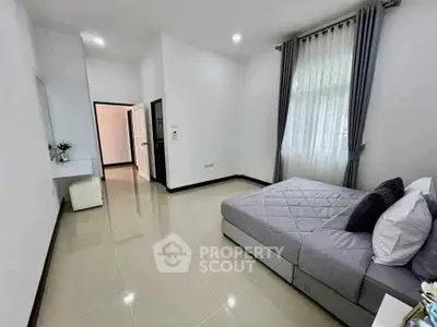 Spacious modern bedroom with elegant decor and natural light