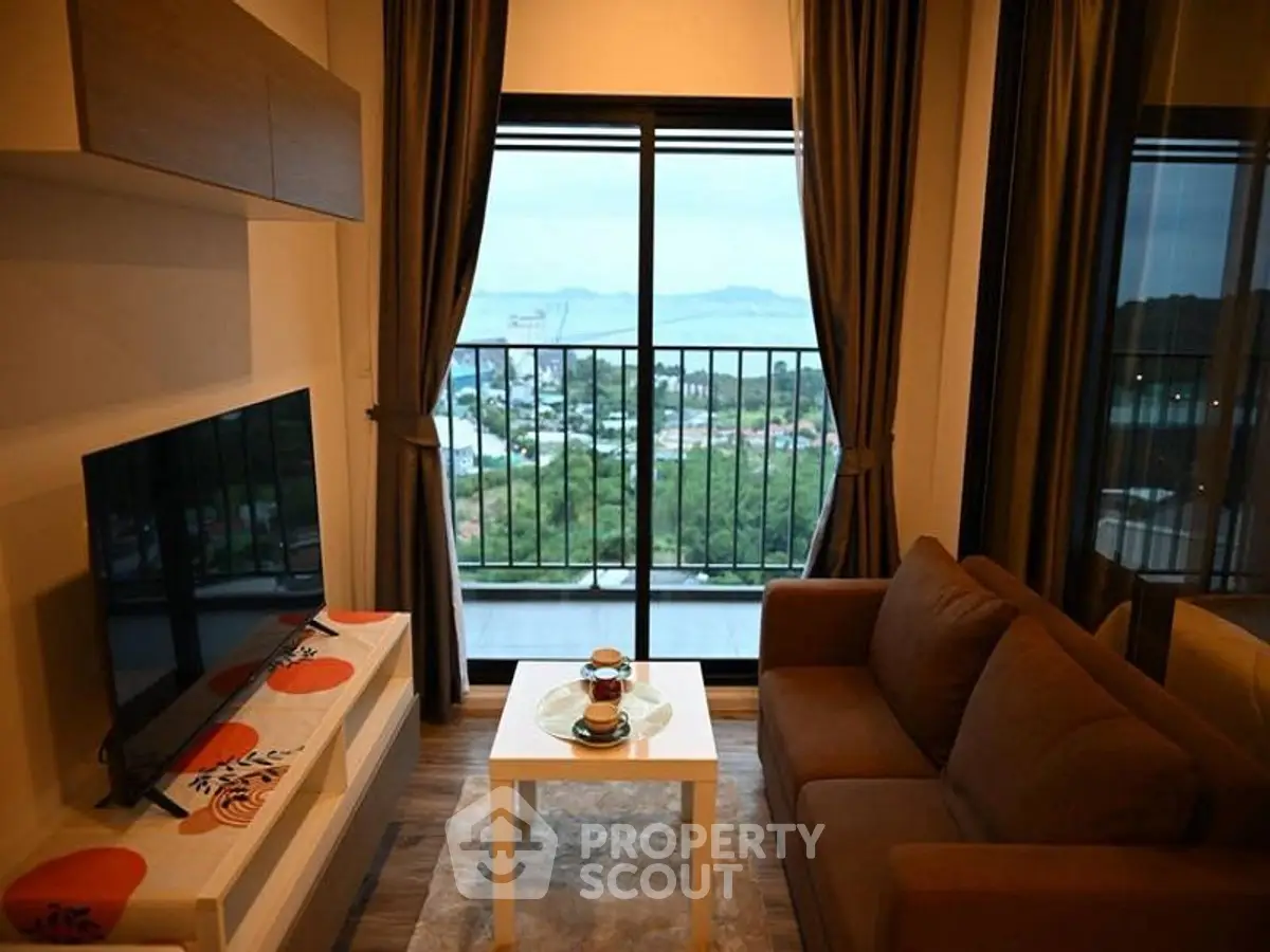 Cozy living room with stunning view from balcony, featuring modern furniture and decor.