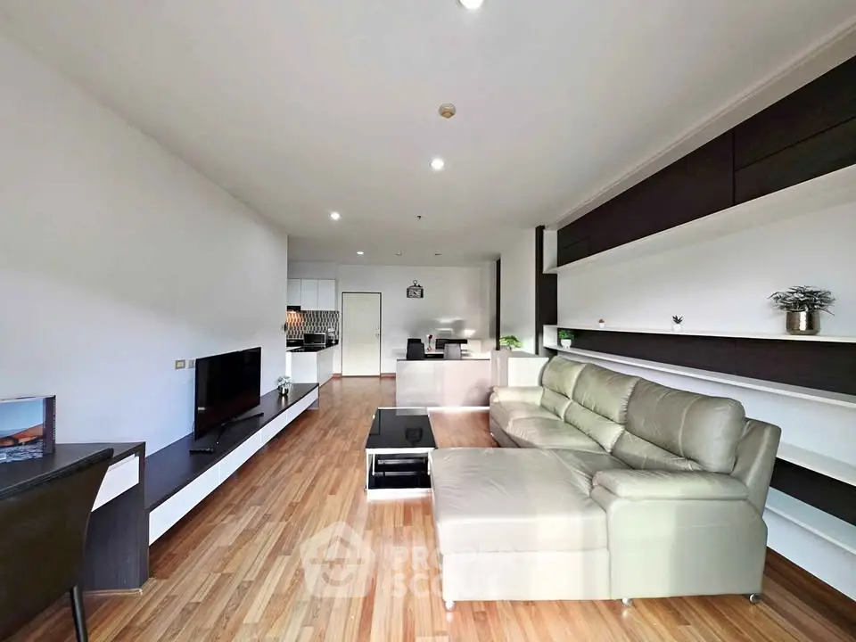 Spacious modern living room with sleek furniture and wooden flooring