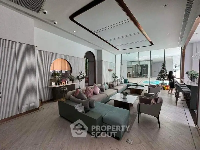 Luxurious living room with modern decor and pool view, perfect for relaxation and entertainment.
