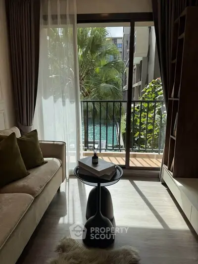 Chic living room with pool view, modern decor, and natural light in luxury apartment.