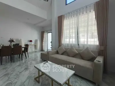 Spacious modern living room with elegant marble flooring and cozy seating area.