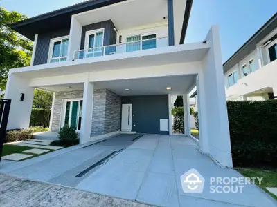 Modern two-story house with spacious driveway and contemporary design