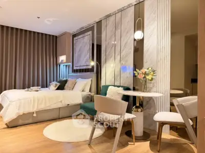 Luxurious modern bedroom with elegant decor and cozy seating area