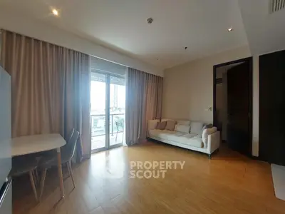 Spacious living room with balcony access and natural light