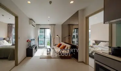 Modern apartment interior with open layout, featuring a cozy living room and two bedrooms.