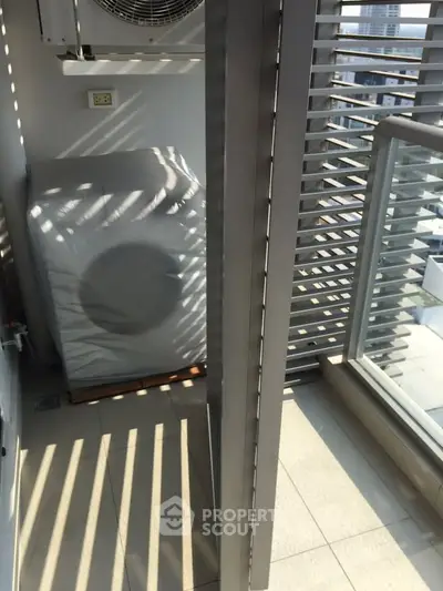 Modern balcony with city view and washing machine, ideal for urban living.