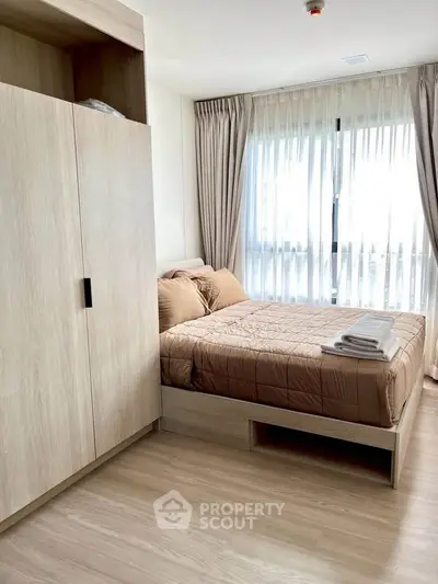 Modern bedroom with natural light and stylish wooden furniture