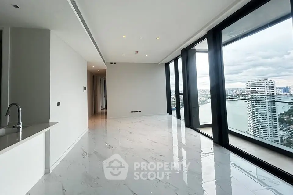 Luxurious high-rise apartment with stunning river views and spacious open-plan living area.