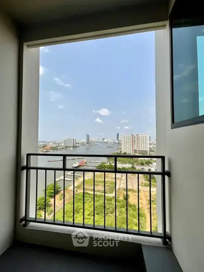 Stunning high-rise balcony view overlooking river and cityscape, perfect for urban living enthusiasts.